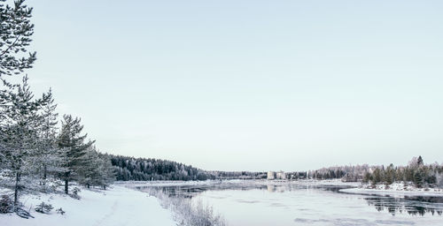 Scenic view of snow covered land against clear sky