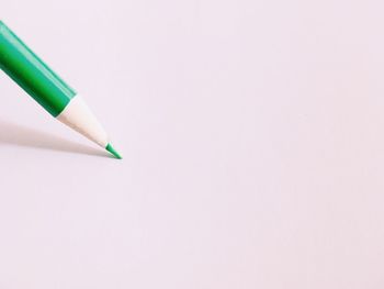 Close-up of colored pencils against white background