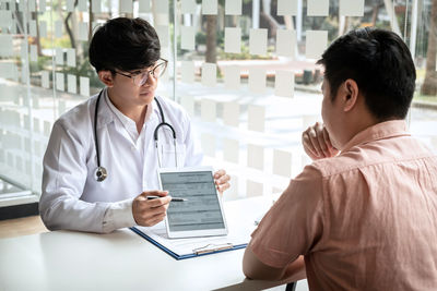 Doctor examining patient in office