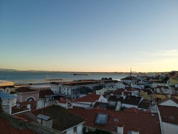 High angle view of townscape by sea against sky