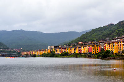 Scenic view of buildings along lakeshore