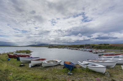 Boats moored in sea against sky