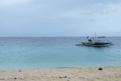 Boat in sea against sky