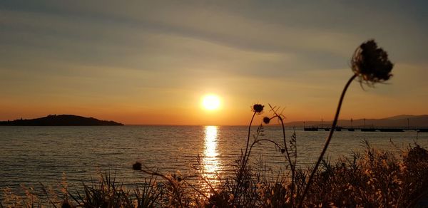 Scenic view of lake against sky during sunset