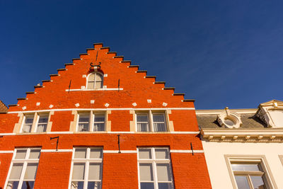 Low angle view of building against blue sky