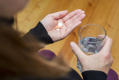 Cropped hand of woman holding drink