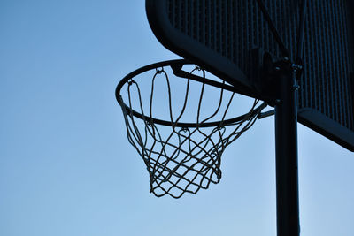 Low angle view of basketball hoop against clear sky