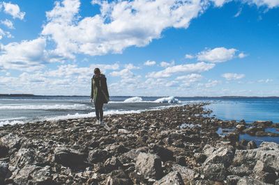 Rear view of woman standing on beach