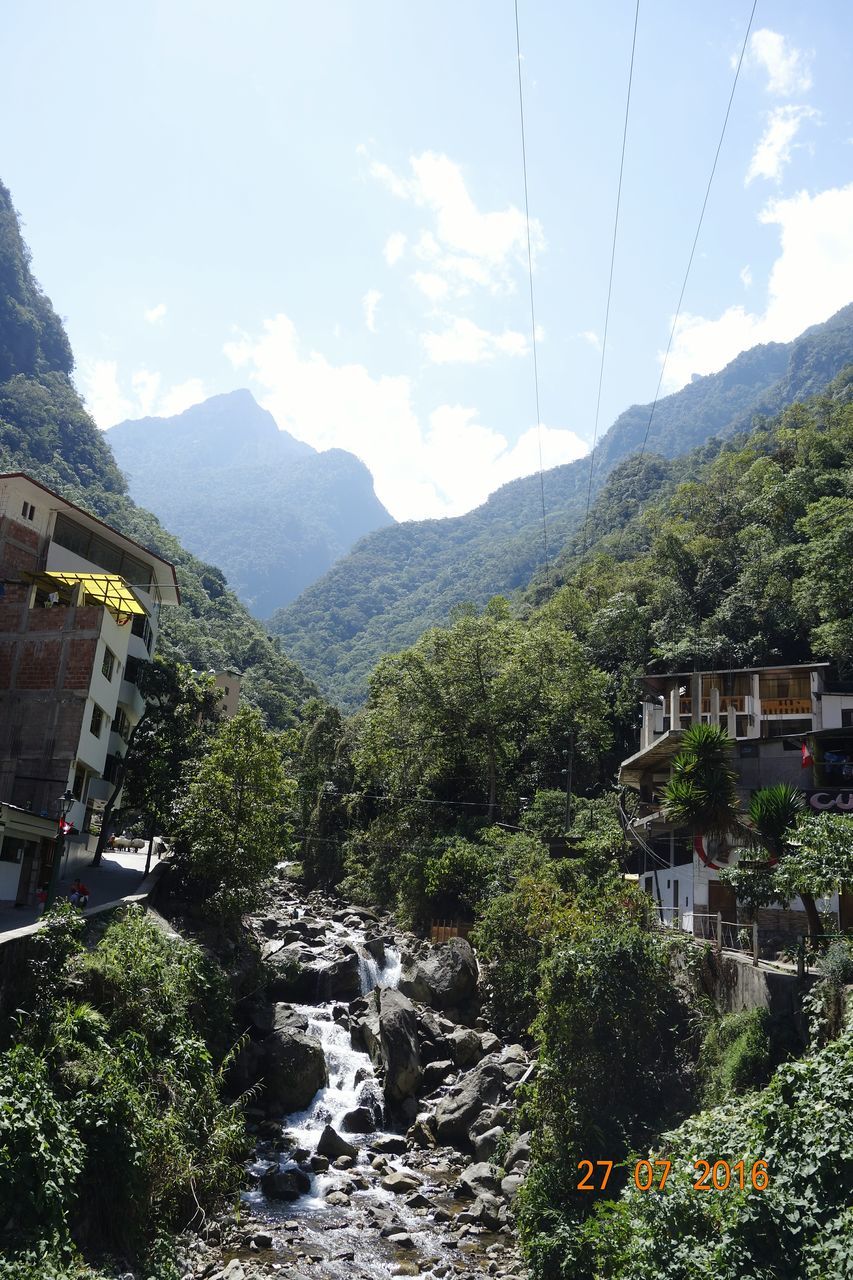 SCENIC VIEW OF RIVER WITH MOUNTAINS IN BACKGROUND