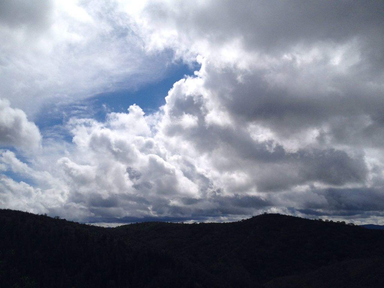 sky, cloud - sky, cloudy, tranquil scene, tranquility, scenics, beauty in nature, cloud, nature, silhouette, cloudscape, weather, overcast, landscape, mountain, low angle view, idyllic, outdoors, storm cloud, no people