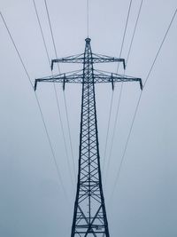 Low angle view of electricity pylon against clear sky