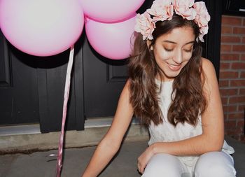 Portrait of young woman with balloons