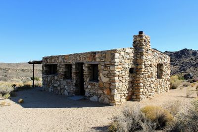 Old ruin building against clear blue sky