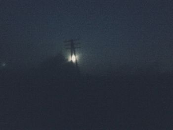 Low angle view of silhouette moon against sky at night