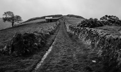 View of trail on landscape against sky