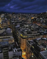 High angle view of illuminated cityscape against sky at dusk