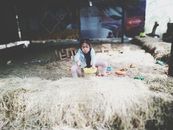 Full length of woman sitting on land