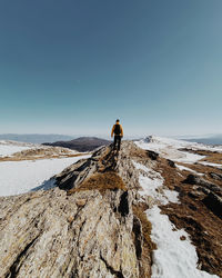 Rear view of man on snow against sky