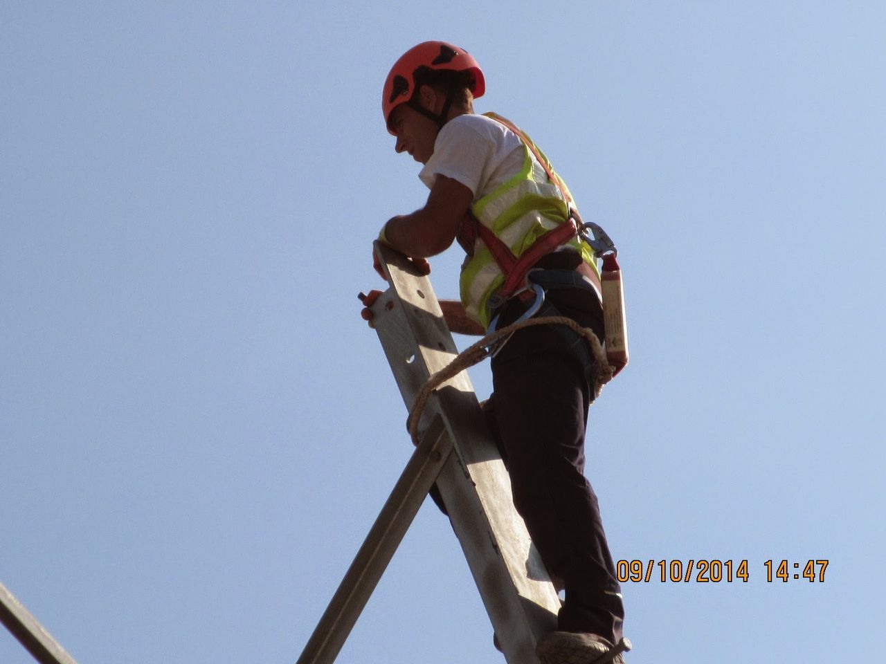 Worker on height health and safety transmission lines Transmission Line Tower Construction Site Helmet Clear Sky Working Men Protective Workwear Climbing Equipment Safety Harness Climbing