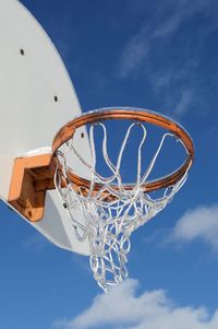 Low angle view of basketball hoop against blue sky