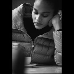 Young woman looking down while sitting at home