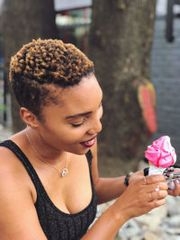 Close-up portrait of woman holding pink ice cream