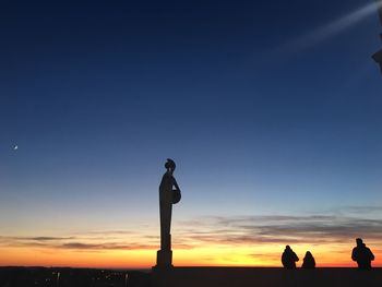 Silhouette man standing against blue sky during sunset