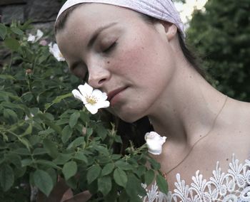 Close-up of beautiful woman with red flower