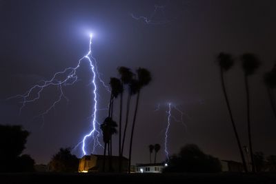 Low angle view of lightning in sky at night