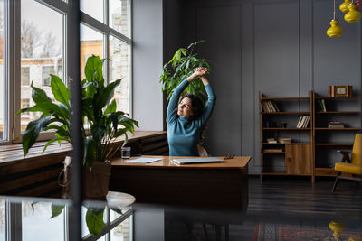 Young relaxed businesswoman relaxing with head over head. taking break during busy workday