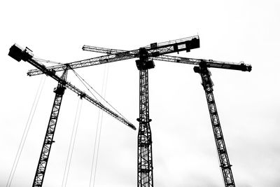 Low angle view of crane against clear sky