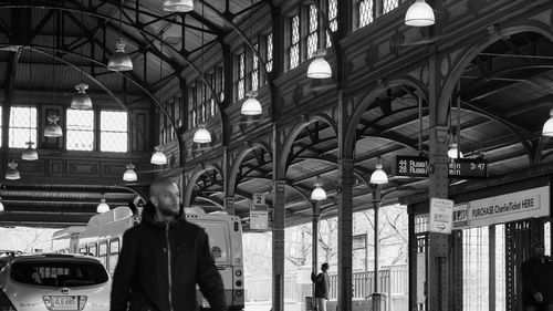 Rear view of man standing at railroad station