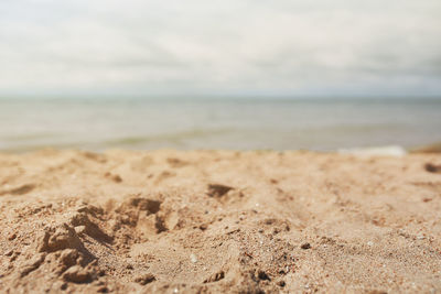 Close-up of sand on beach against sky