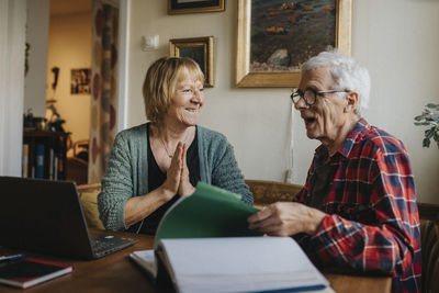 Senior couple using laptop at home