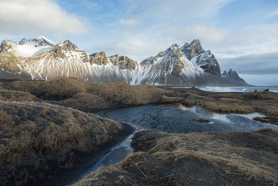 Scenic view of lake and mountains against sky