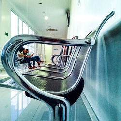 Side view of man cycling in shopping mall