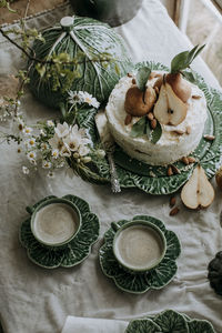 Pear cake and coffee cups on table