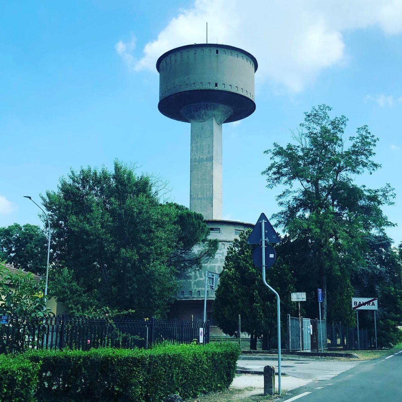 LOW ANGLE VIEW OF WATER TOWER AMIDST TREES AGAINST SKY