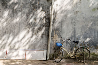 Bicycle leaning against wall