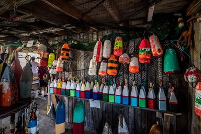 Multi colored hanging buoys for sale in fish market.