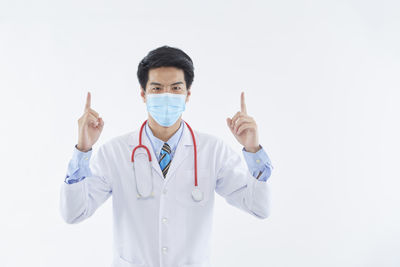 Portrait of man standing against white background