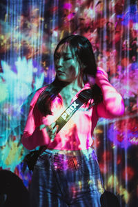 Full length of a woman playing guitar