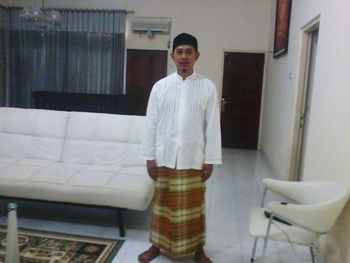 Portrait of young man standing indoors