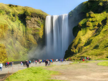 People against waterfall