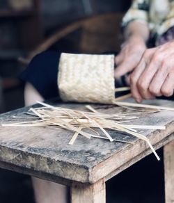 Cropped hand of man working on table