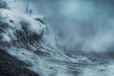 Dramatic view of the sea against the lighthouse...