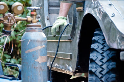 Cropped hand of male mechanic repairing vehicle