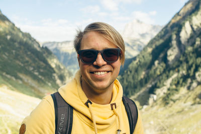 Portrait of smiling young man in mountain valley