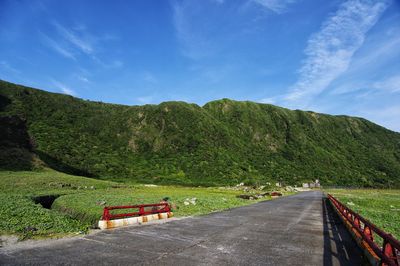 Road amidst trees against sky