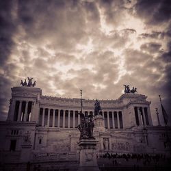 Low angle view of historical building against cloudy sky